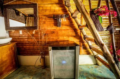 a room with a wooden cabin with a tv in it at Valle Bucana in Santa Bárbara de Samaná