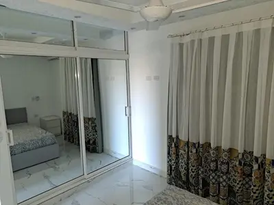 a bedroom with a bed and a large glass window at CASA MARAVILLOSA in Bayahibe