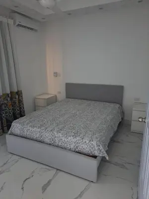 a white bedroom with a bed in a room with marble floors at CASA MARAVILLOSA in Bayahibe