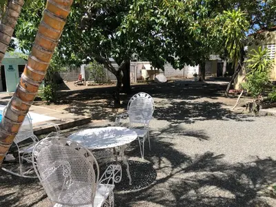 a table and chairs sitting under a tree at Villa Luz in Baní