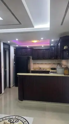 a kitchen with black cabinets and a counter top at SANTIAGO PARADISE 111 S 3 in Santiago de los Caballeros