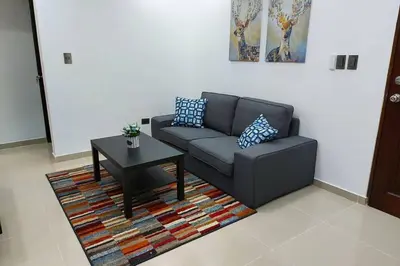 a living room with a couch and a table at 4to nivel 2 habitaciones 2 baños Alma Rosa I in El Seis