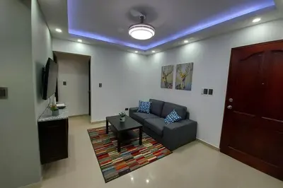 a living room with a couch and a table at 4to nivel 2 habitaciones 2 baños Alma Rosa I in El Seis
