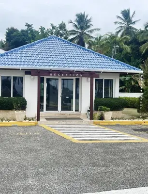 a building with a blue roof on top of it at Spectacular Ocean View Spacious 2-Bedroom Condo, Vista Mare, Samana DR in Santa Bárbara de Samaná