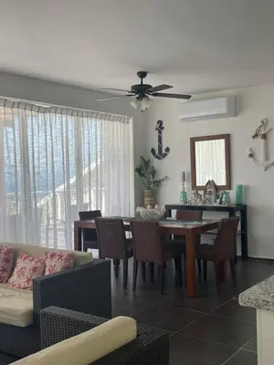 a living room with a couch and a table with chairs at Spectacular Ocean View Spacious 2-Bedroom Condo, Vista Mare, Samana DR in Santa Bárbara de Samaná