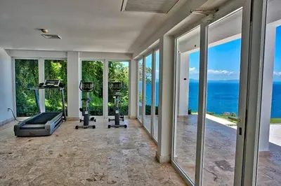 an empty gym with a view of the ocean at Spectacular Ocean View Spacious 2-Bedroom Condo, Vista Mare, Samana DR in Santa Bárbara de Samaná