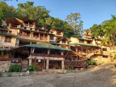 a building with balconies on the side of a mountain at Altos de Caño Hondo in Los Guineos Perdidos