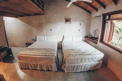 a bedroom with two beds in a room at Altos de Caño Hondo in Los Guineos Perdidos