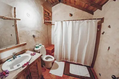 a bathroom with a sink and a toilet and a shower at Altos de Caño Hondo in Los Guineos Perdidos