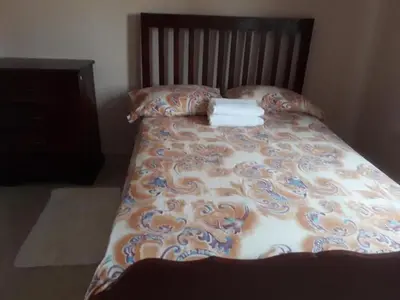a bed with a blanket and two towels on it at Apartahotel Next Nivel - Queen Room with Fan in Punta Cana