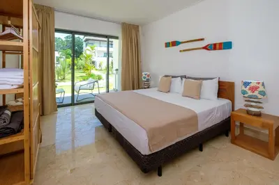 a bedroom with a large bed and a balcony at Amar'e Aparthotel & Spa in Las Terrenas