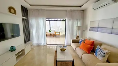 a living room with a couch and a table at Amar'e Aparthotel & Spa in Las Terrenas