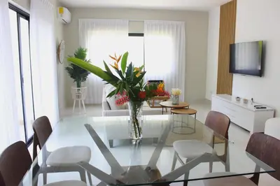 a living room with a glass table and chairs at Amar'e Aparthotel & Spa in Las Terrenas