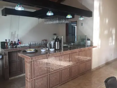 a kitchen with a counter with a sink and a mirror at Hotel Santander SD in Santo Domingo