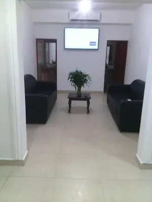 a living room with black couches and a table at Hotel Santander SD in Santo Domingo