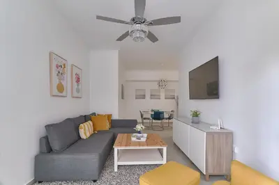 a living room with a couch and a table at Dom. Rep. Exclusive 2 bed Apt. Evaristo Morales in Santo Domingo