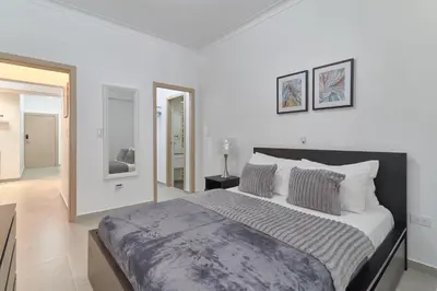 a white bedroom with a large bed in it at Dom. Rep. Exclusive 2 bed Apt. Evaristo Morales in Santo Domingo