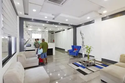 two people are standing in a living room at Hotel Señorial in Santo Domingo