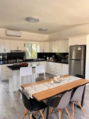 a kitchen with a table with chairs and a refrigerator at Apartamento Carey in Cabrera