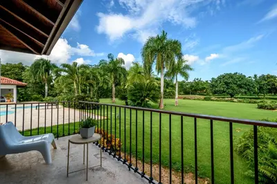 a balcony with a view of a park at Casa de Campo Luxury Villas - Private Paradise at La Romana in La Romana