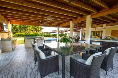an outdoor dining area with a table and chairs at Casa de Campo Luxury Villas - Private Paradise at La Romana in La Romana