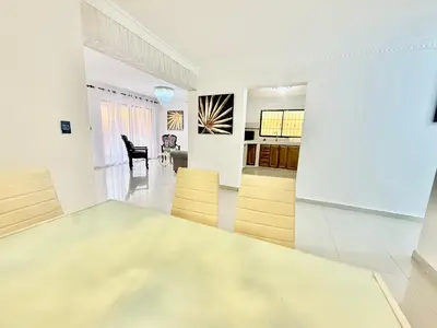 a dining room and living room with a glass table at Apartment Travis l in La Viva