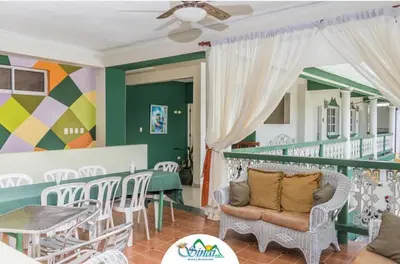 a room with a balcony with a table and chairs at Hotel Sinai in Nagua