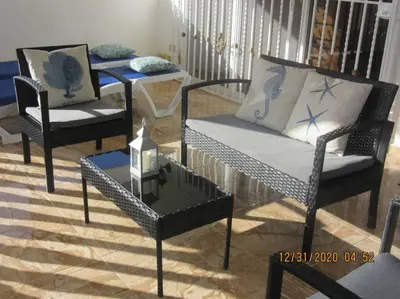a living room with two chairs and a table at Pelicano Tropical Paraiso Samana in Santa Bárbara de Samaná