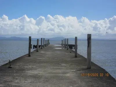 a pier in the middle of the water at Pelicano Tropical Paraiso Samana in Santa Bárbara de Samaná