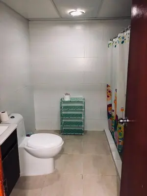 a bathroom with a white toilet and a shower at Apartamento estudio frente al mar in Guayacanes