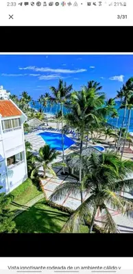 a picture of a house with palm trees in front of it at Apartamento estudio frente al mar in Guayacanes