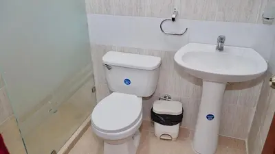 a bathroom with a toilet and a sink at Vistabalcon Aire y Neflix in La Guáyiga