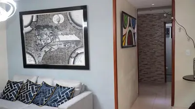 a living room with a couch and a painting on the wall at Vistabalcon Aire y Neflix in La Guáyiga