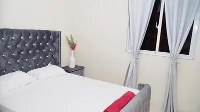 a bedroom with a white bed and a window at Vistabalcon Aire y Neflix in La Guáyiga