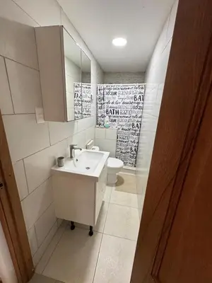 a white bathroom with a sink and a toilet at Paradise Suite Cadaqués in Bayahibe