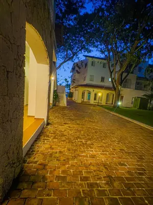 a cobblestone street in front of a building at night at Paradise Suite Cadaqués in Bayahibe