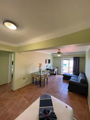 a living room with a couch and a table at Villa Iguana in Bayahibe