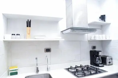 a white kitchen with a sink and a stove at S1404 Vista espectacular Downtown Santo Domingo in Santo Domingo