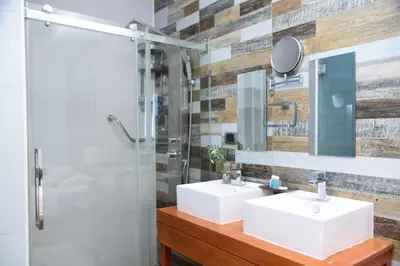 a bathroom with two sinks and a shower at S1404 Vista espectacular Downtown Santo Domingo in Santo Domingo