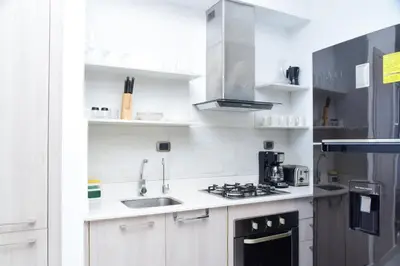 a white kitchen with a sink and a stove at S1404 Vista espectacular Downtown Santo Domingo in Santo Domingo