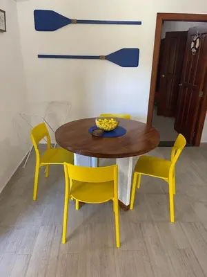 a table and chairs with a bowl of flowers on it at Las Terrenas beachfront 2 bedrooms condo with pool in Las Terrenas