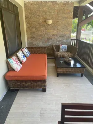 a porch with a couch and a coffee table at Las Terrenas beachfront 2 bedrooms condo with pool in Las Terrenas