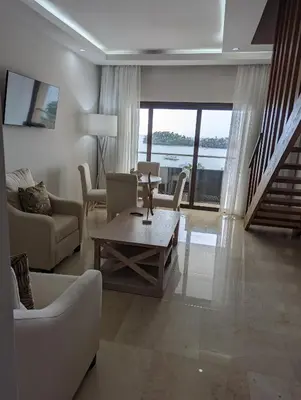 a living room with a couch and a coffee table at Hacienda Samana Bay Hotel in Santa Bárbara de Samaná