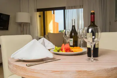 a table with two bottles of wine and a plate of fruit at Hacienda Samana Bay Hotel in Santa Bárbara de Samaná