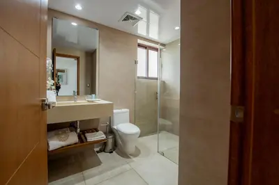 a bathroom with a toilet and a sink and a shower at Hacienda Samana Bay Hotel in Santa Bárbara de Samaná
