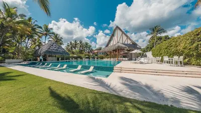 a swimming pool with lounge chairs and a resort at Newly Added 1BR El Portillo Luxury in Portillo