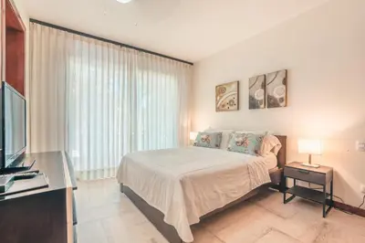 a bedroom with a bed and a large window at Newly Added 1BR El Portillo Luxury in Portillo