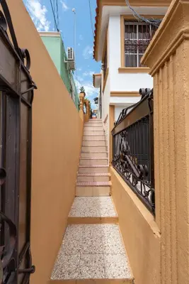 a stairway leading up to a building with a stairwayngthngthngthngth at Acogedor Espacio en Santo Domingo Este. in Mandinga
