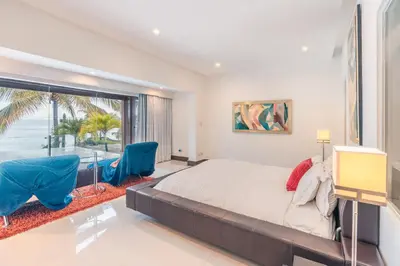 a bedroom with a large bed and a large window at Townhouse with ocean view Puerto Bahia in Los Grini