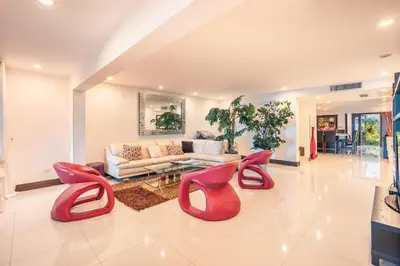 a living room with red chairs and a couch at Townhouse with ocean view Puerto Bahia in Los Grini